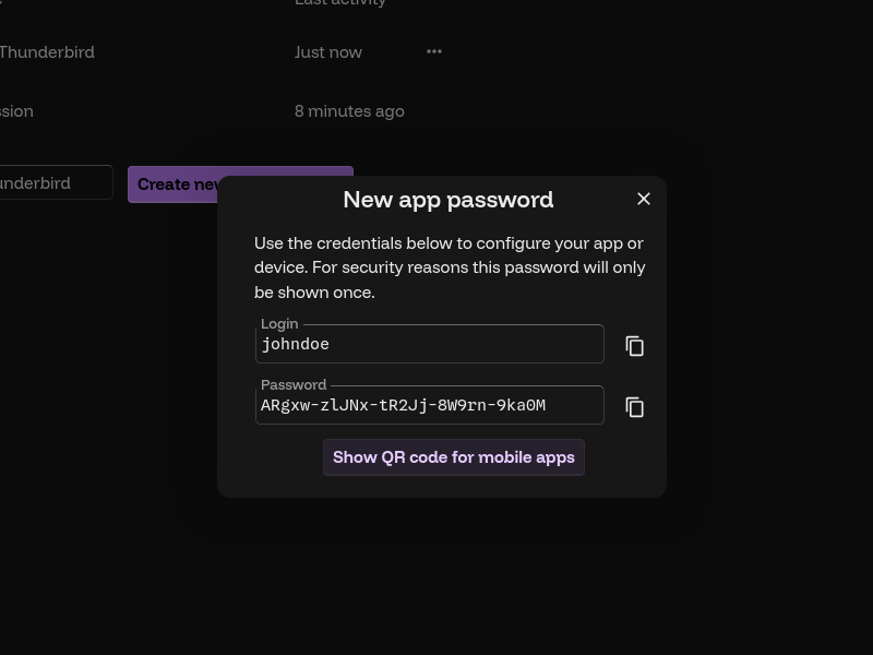 The previous scene, with a new dialog titled "New app password" in place of the authentication dialog. It displays a login, "johndoe", and a randomly-generated password, "ARgxw-zlJNx-tR2Jj-8W9rn-9ka0M". These credentials will be used throughout the guide.